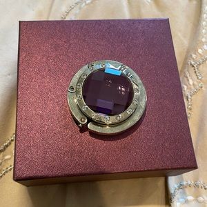 Purse holder for hooking under table. Pretty purple!